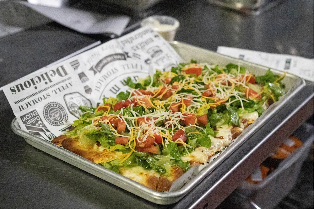 CJ’s flatbread topped with bacon, lettuce and tomato
