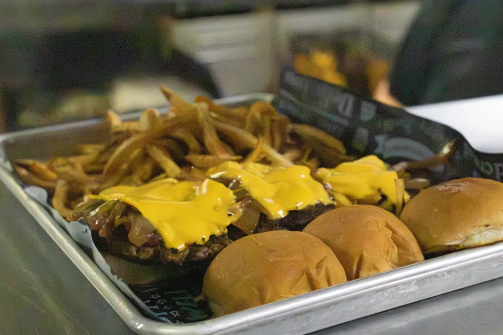 Three CJ’s beef sliders with American cheese and fries