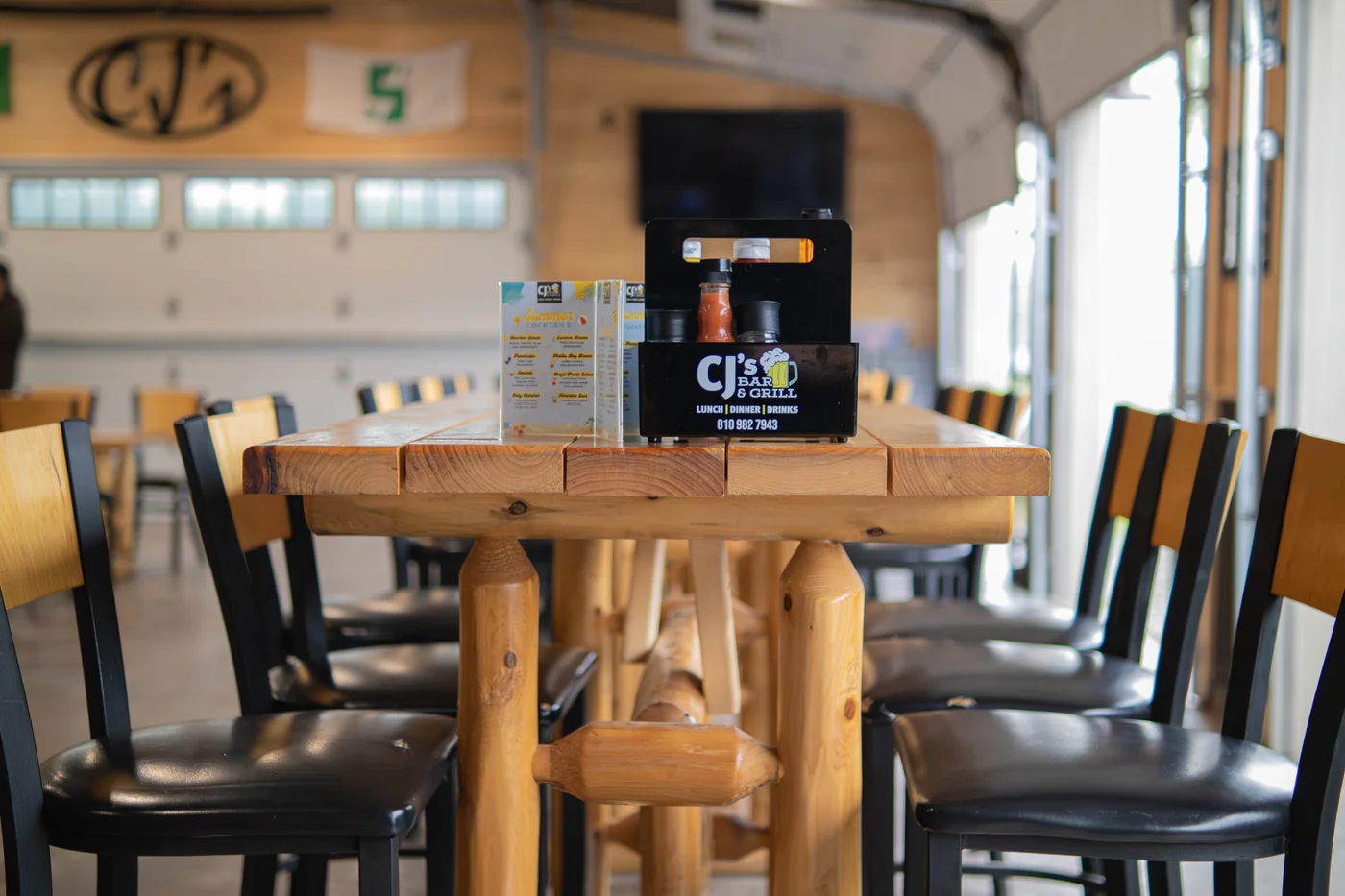 Warm wood tables and seating in CJ’s dining room